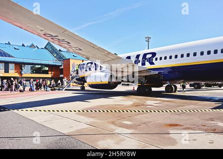 Crowd of people boarding an airplane in airport Stock Photo