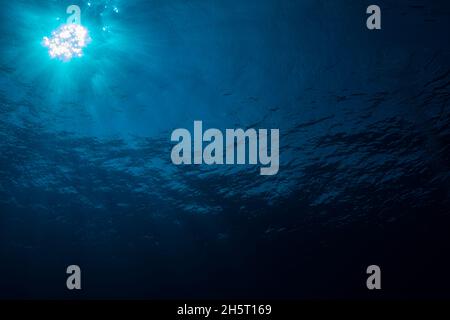 Beautiful sun with sunrays from deep of blue ocean looks majestic Stock Photo