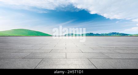Empty square floor and green mountain background. Stock Photo
