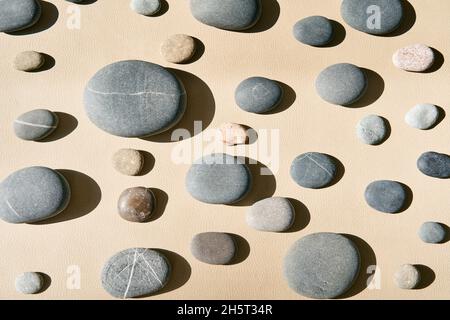 Stone wall texture background. Different kind of pebbles stones against light background. Stock Photo