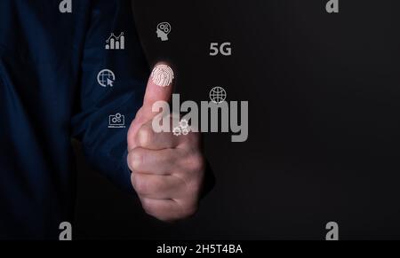 Fingerprint scan provides security access with biometrics identification, person touching screen with finger in background Stock Photo