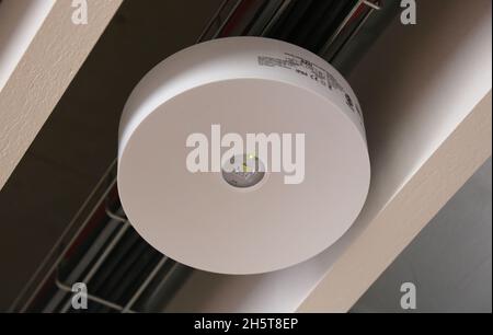 Cracow. Krakow. Poland.The emergency lighting lamp guiding light to escape fire during fire accidents in modern office building. Stock Photo