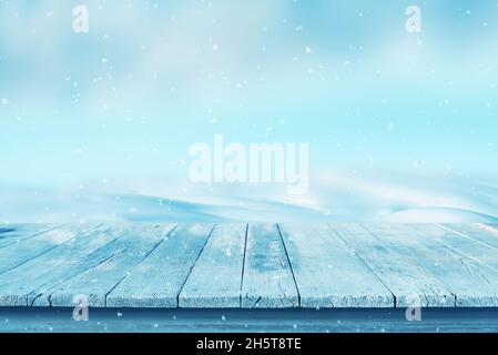 Empty wooden desk with snow in the background. Cold, winter scene for product promotion Stock Photo