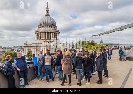 LONDON, UNITED KINGDOM - OCTOBER 4, 2017: People at the observation deck of One New Change Rooftop in London look at the cupola of St. Paul's Cathedra