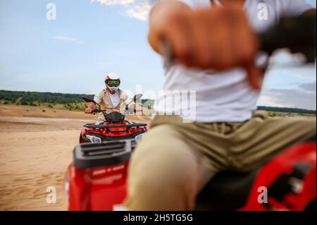 Two travelers, atv riding in desert sands Stock Photo