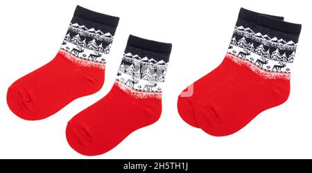 Pair of blue red nordic socks with deer and snowflake geometric ornament isolated on a white background Stock Photo