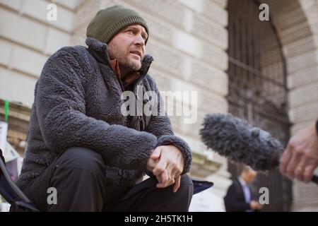 London, UK. 11th November, 2021. Richard Ratcliffe at his temporary camp on Day 19 of his hunger strike in front of the UK Foreign Office. Husband of Nazanin Zaghari-Ratcliffe, a British-Iranian held in Iran since 2016, sits outside the Foreign, Commonwealth and Development Office to denounce the British government failing to secure her release.  Credit: Sam Mellish / Alamy Live News Stock Photo