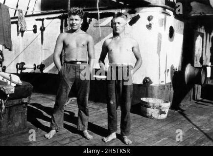 Two sailors standing on the deck of the four-masted steel barque Hougomont, circa 1928. Stock Photo