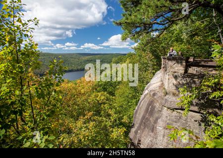 Warren, Pennsylvania - A photographer perched in an overlook above the Allegheny Reservoir in the Allegheny National Forest. Stock Photo