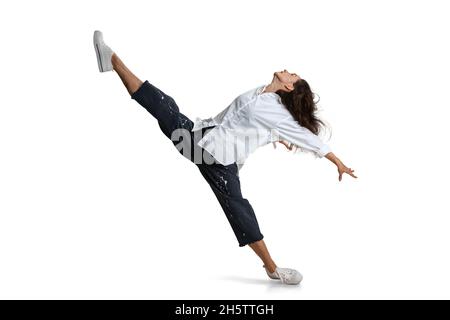 Dynamic portrait of flexible woman, contemp dancer isolated on white background. Art, motion, action, flexibility, inspiration concept. Stock Photo