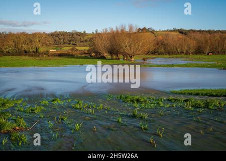 Flood waters on Aller Common Moor from where the River Parrett overflows its banks down the spillway close to Monks Leaze Clyse. Somerset, England, UK Stock Photo
