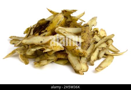 Potato skins after peeling potatoes. Organic waste for compost. Pile of vegetable garbage isolated on white background. Stock Photo