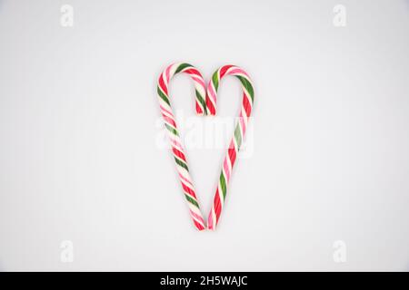 Red candy cane striped in Christmas colours hearts on a white background Stock Photo