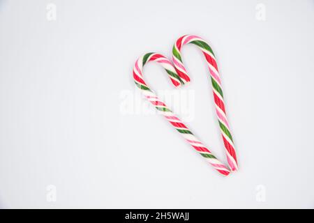 Red candy cane striped in Christmas colours hearts on a white background Stock Photo