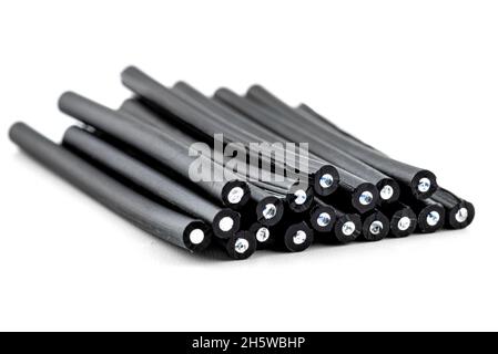 A stack of cut fiber optic cables lying on top of each other, isolated on a white background. Stock Photo