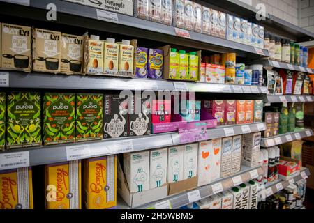 Vegan corner shop with a large variety of products on shelves and fridges Stock Photo