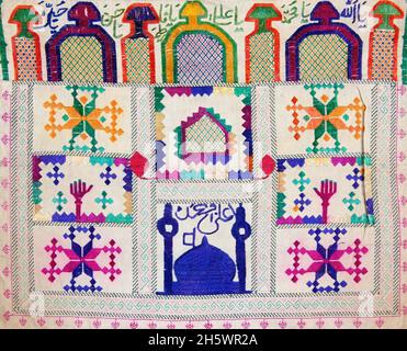 Detail of Hazara prayer stone cloth Afghanistan. Embroidered cloths with minaret; mosque; Arabic characters; prayer niche motifs. Prayer stone cloths are used to hold the prayer stone (mohr or turba) used by Shiite muslims. The prayer stones are made of baked clay from Karbala. The prayer stones are kept wrapped in the cloths in the house or on the body. When praying one puts the prayer stone cloth on the prayer rug. Prayer cloths and stones are placed on the prayer rug in such a way that one touches the stone with one's forehead when bending over during prayer. Stock Photo