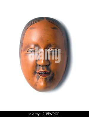 Japanese carved wood netsuke, nneteenth century, measuring 4.2x2.8x1.6cm approx.   A belt knot (netsuke) served to keep a storage box in place, hanging from the kimono belt. They are often inventively decorated in the most diverse shapes and with his choice the wearer was able to showcase his individual taste. With these three masks, the owner obviously showed his love for Noh theatre.  25MB Stock Photo