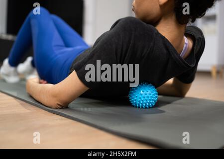 African American Woman Massage Treatment With Ball Stock Photo