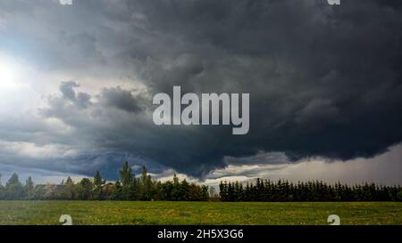 Angry Storm Clouds at summer in the meadow Stock Photo