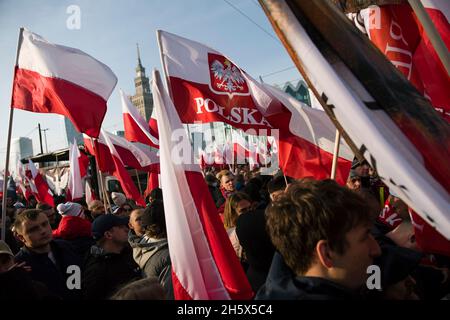 Warsaw, Poland. 11th Nov, 2021. Participants of the march wave Polish flags during the Independence March.Poland's National Independence Day marks the anniversary of the country's independence in 1918. It is celebrated as a nationwide holiday on November 11 each year. This year again tens of thousands of Poles took part in the Independence Day March in Warsaw organized by far-right organizations to celebrate the 103rd anniversary of Poland's rebirth as an independent state. The slogan of the march was: 'Independence is not for sale!”. Credit: SOPA Images Limited/Alamy Live News Stock Photo