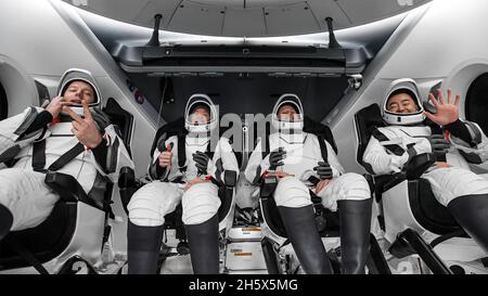 Pensacola, Florida, USA. 8th Nov, 2021. ESA (European Space Agency) astronaut Thomas Pesquet, left, NASA astronauts Megan McArthur and Shane Kimbrough, and Japan Aerospace Exploration Agency (JAXA) astronaut Aki Hoshide, right, are seen inside the SpaceX Crew Dragon Endeavour spacecraft onboard the SpaceX GO Navigator recovery ship shortly after having landed in the Gulf of Mexico off the coast of Pensacola. Credit: Aubrey Gemignani/NASA/ZUMA Wire/ZUMAPRESS.com/Alamy Live News Stock Photo