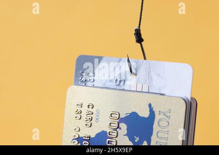 Fishing hook with credit cards on laptop, closeup. Cyber crime Stock Photo  - Alamy