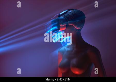 Dummy of Woman in futuristic VR goggles placed under bright projection in dim room Stock Photo