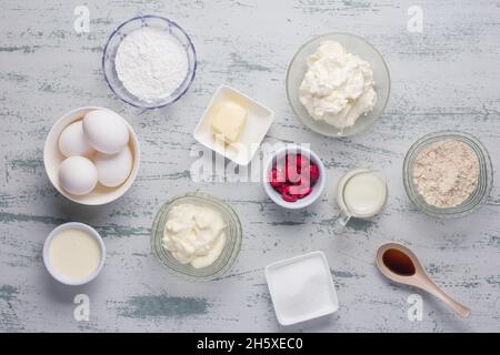 Top view of various ingredients for low carbohydrates keto crepes with raspberries and erythritol sweetener placed on table in light kitchen Stock Photo