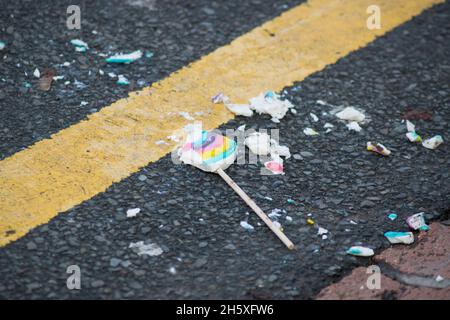 Colorful lollipop dropped and broken on the road Stock Photo