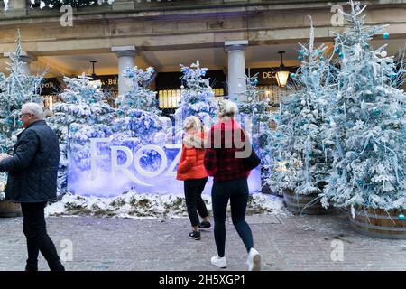 Tourists taking selfie at Frozen Musical decoration on Christmas tree Covent Garden London England UK Stock Photo