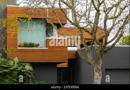 Beautiful modern architecture - low energetic wooden panels house and garden. Modern country house villa from the wood. Stock Photo