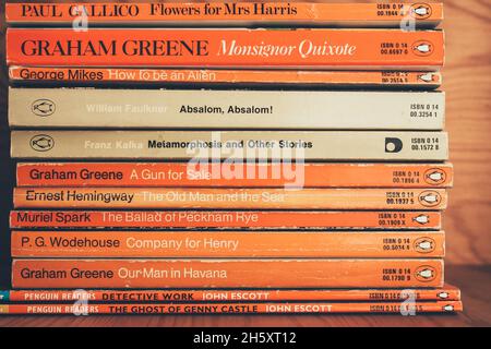 MADRID, SPAIN - Nov 11, 2021: Collection of old Penguin books on wooden shelf. Vintage penguin books at a bookstore. Stock Photo