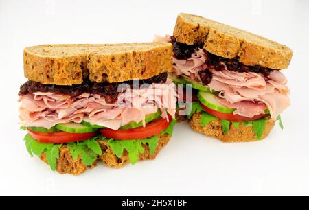 Ham and salad sandwiches In crusty brown bread slices with pickle relish Stock Photo