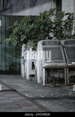 Vertical shot of old abandoned arcade machines on the side of a road Stock Photo