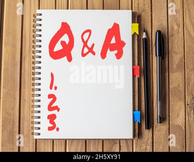 Writing displaying text Q And A. Word Written on in which person asks questions and another one answers them Blank Open Spiral Notebook With Diffrent Stock Photo