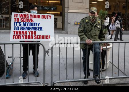 New York, USA. 11th Nov, 2021. New Yorkers line the street along 5th Avenue for the 102nd Veterans Day Parade in New York, New York, on Nov. 11, 2021. (Photo by Gabriele Holtermann/Sipa USA) Credit: Sipa USA/Alamy Live News Stock Photo