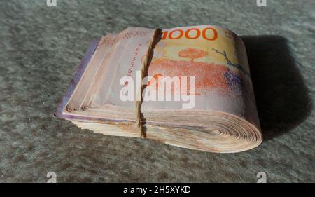 wad of bank notes tied with elastic band Stock Photo