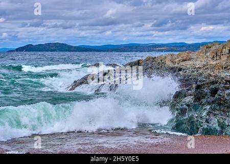 Waves crash against the rocks along the north shore of Lake Superior in Ontario Canada. Stock Photo