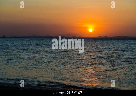 Salvador, Bahia, Brazil - October 29, 2015: Sunset seen from Ribeira beach in Salvador, Bahia, Brazil. Stock Photo