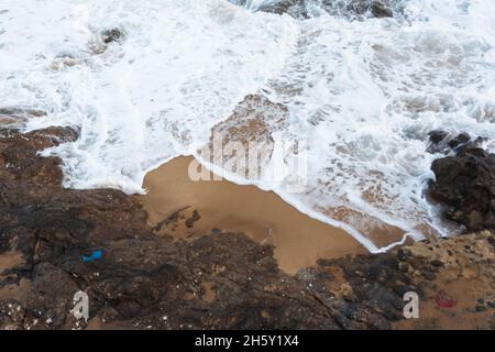 Sea waves from Praia do Rio Vermelho breaking on the clear sands. Salvador, Bahia, Brazil. Stock Photo