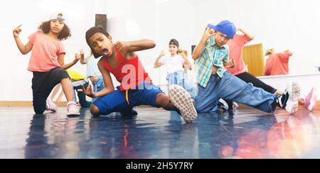 Happy tweens practicing hip hop in dance studio Stock Photo
