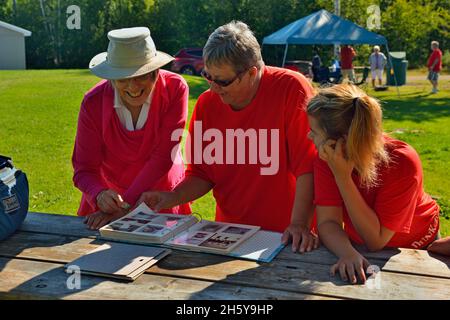 Candid portrait from a family gathering. Looking at photos, Greater Sudbury, Ontario, Canada Stock Photo