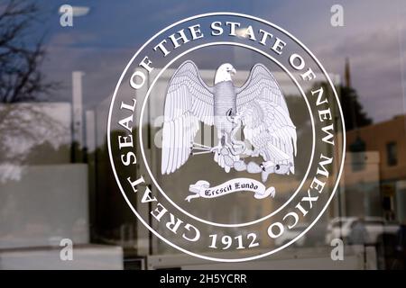 Great Seal of the state of New Mexico with Crescit Eundo, It grows as it goes, motto on glass entrance door - Santa Fe, New Mexico, USA - 2021 Stock Photo