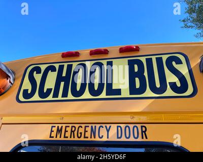 School bus sign above rear emergency exit door. Close up Stock Photo