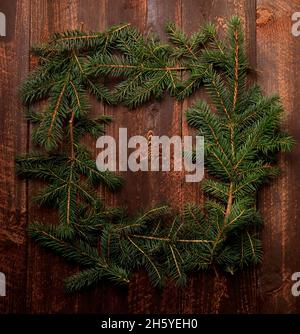 Christmas Tree Fir Branch Frame on a Dark Wooden Background Stock Photo