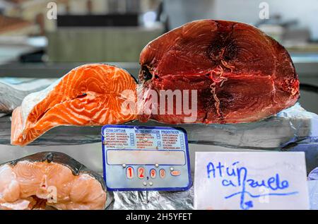 Cuts of freshly caught raw salmon and tuna and bass for sale at a local fishmonger stall at the market in old town or Casco Viejo in Pamplona, Spain. Stock Photo