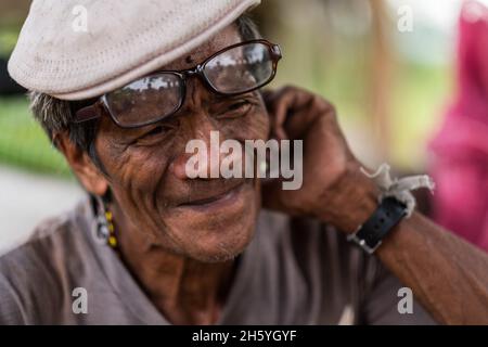 July 2017. Arenesto Deguen works at making products from ratan. Local handicrafts like this add value over simply harvesting the ratan, but are difficult to market and capitalize on without a better distribution system. Aborlan, Barangay Sagpangan, Palawan, Philippines. Stock Photo