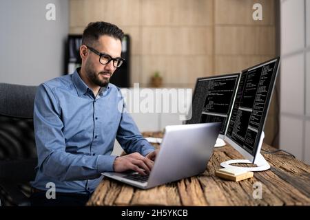 Coder Using Computer At Desk. Web Developer Stock Photo