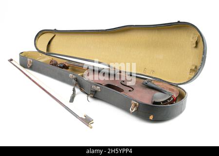 Wide closeup studio shot of old, broken, dust covered violin with its old, scratched case, isolated on white background. Vintage damaged musical Stock Photo